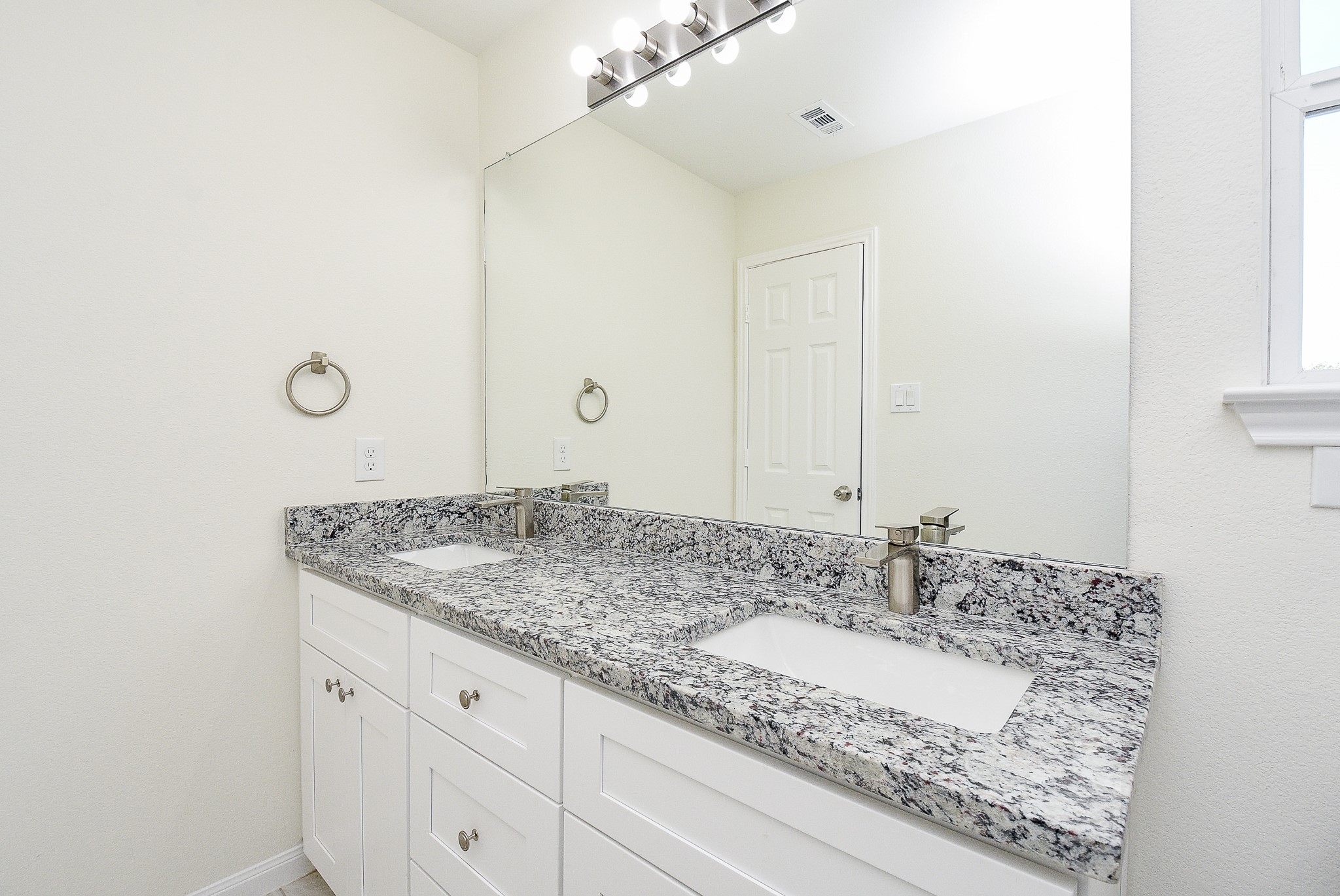 12214 Heather Flower Lane Houston, TX 77014 - Photo 22 of 32 a bathroom with a granite countertop sink and a mirror