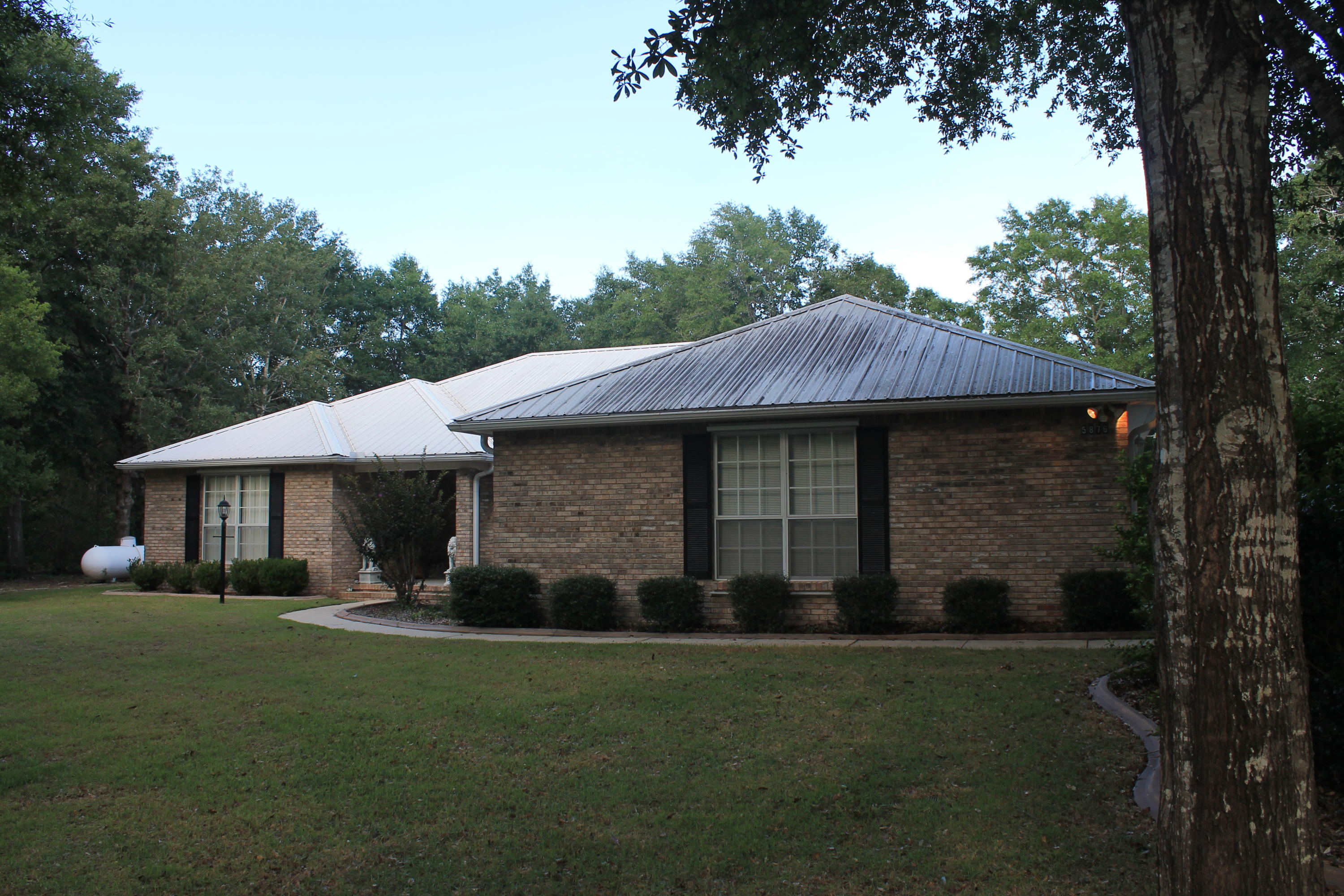 5876 Ward Ranch Road Crestview, FL 32536 - Photo 3 of 50 a front view of a house with a garden