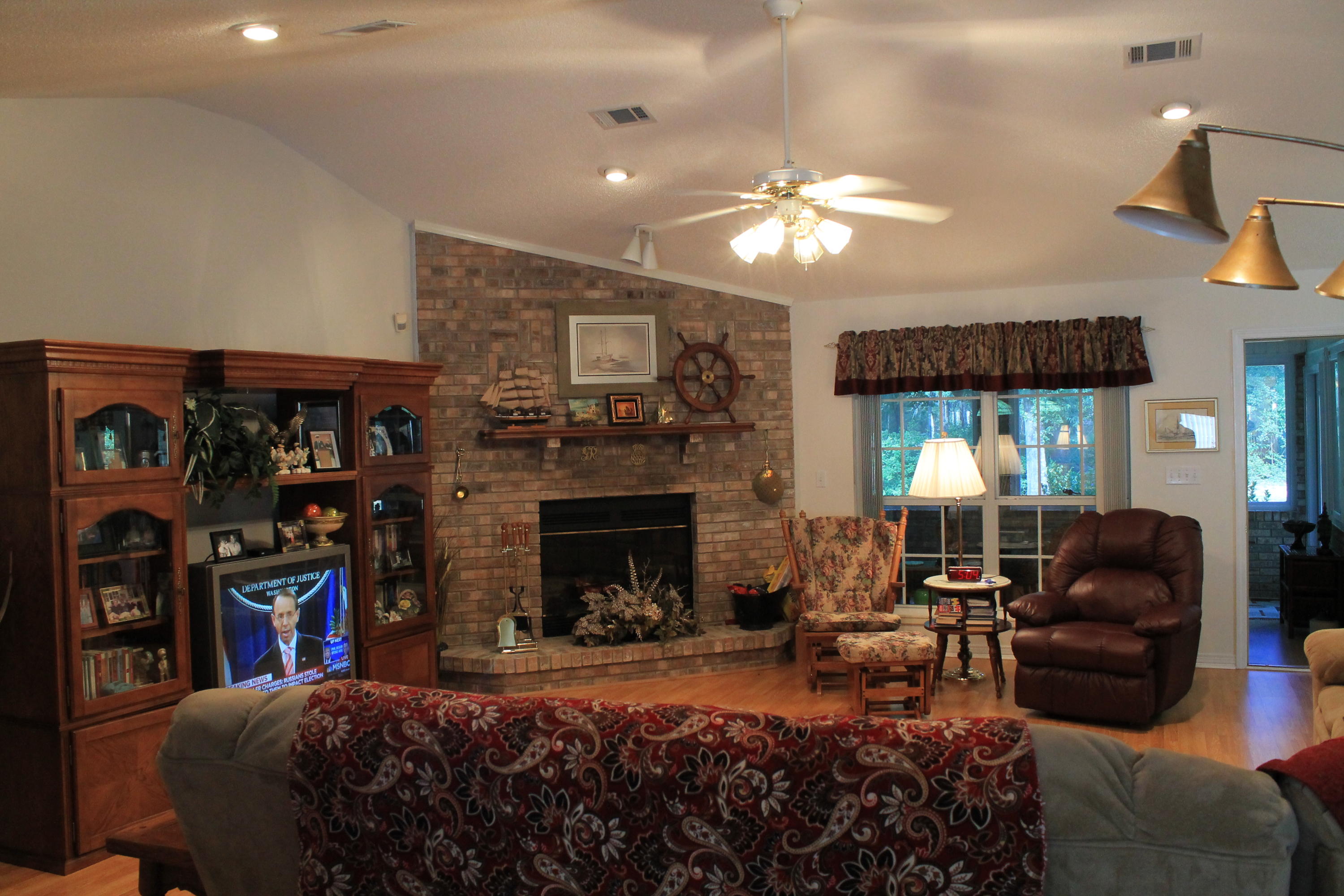 5876 Ward Ranch Road Crestview, FL 32536 - Photo 26 of 50 a living room with furniture a bookshelf and a fireplace