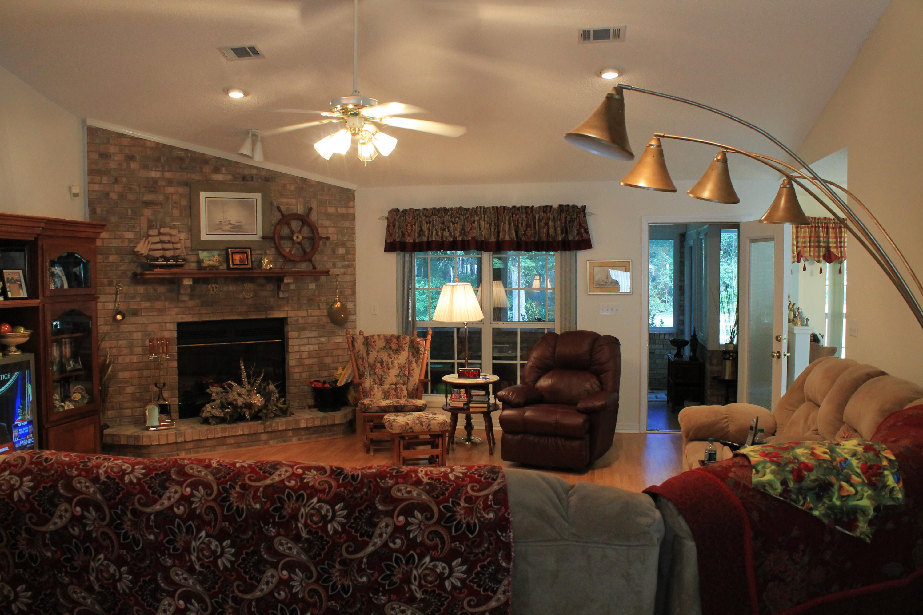 5876 Ward Ranch Road Crestview, FL 32536 - Photo 27 of 50 a living room with furniture a large window and a fireplace