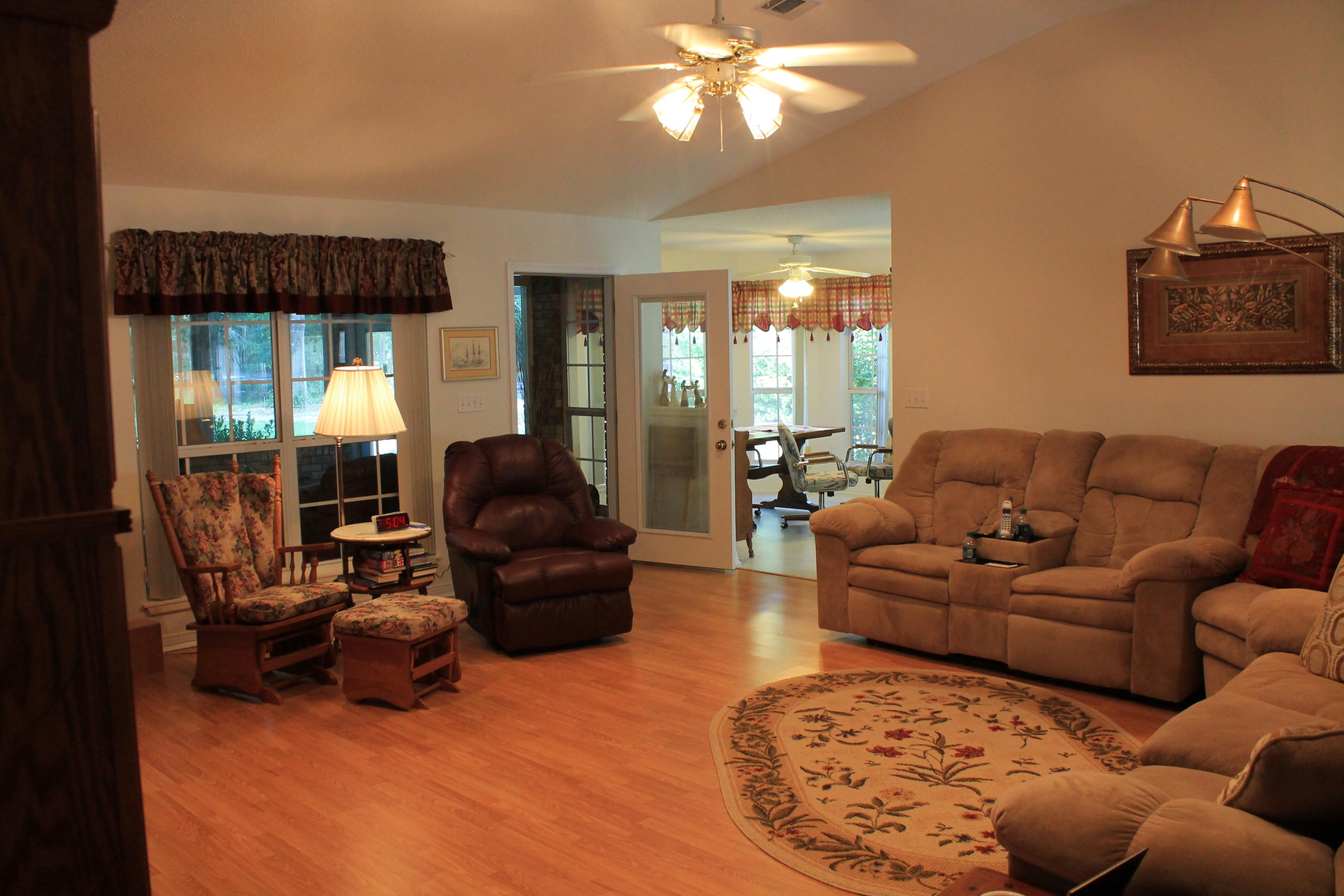 5876 Ward Ranch Road Crestview, FL 32536 - Photo 29 of 50 a living room with furniture a lamp and a large window