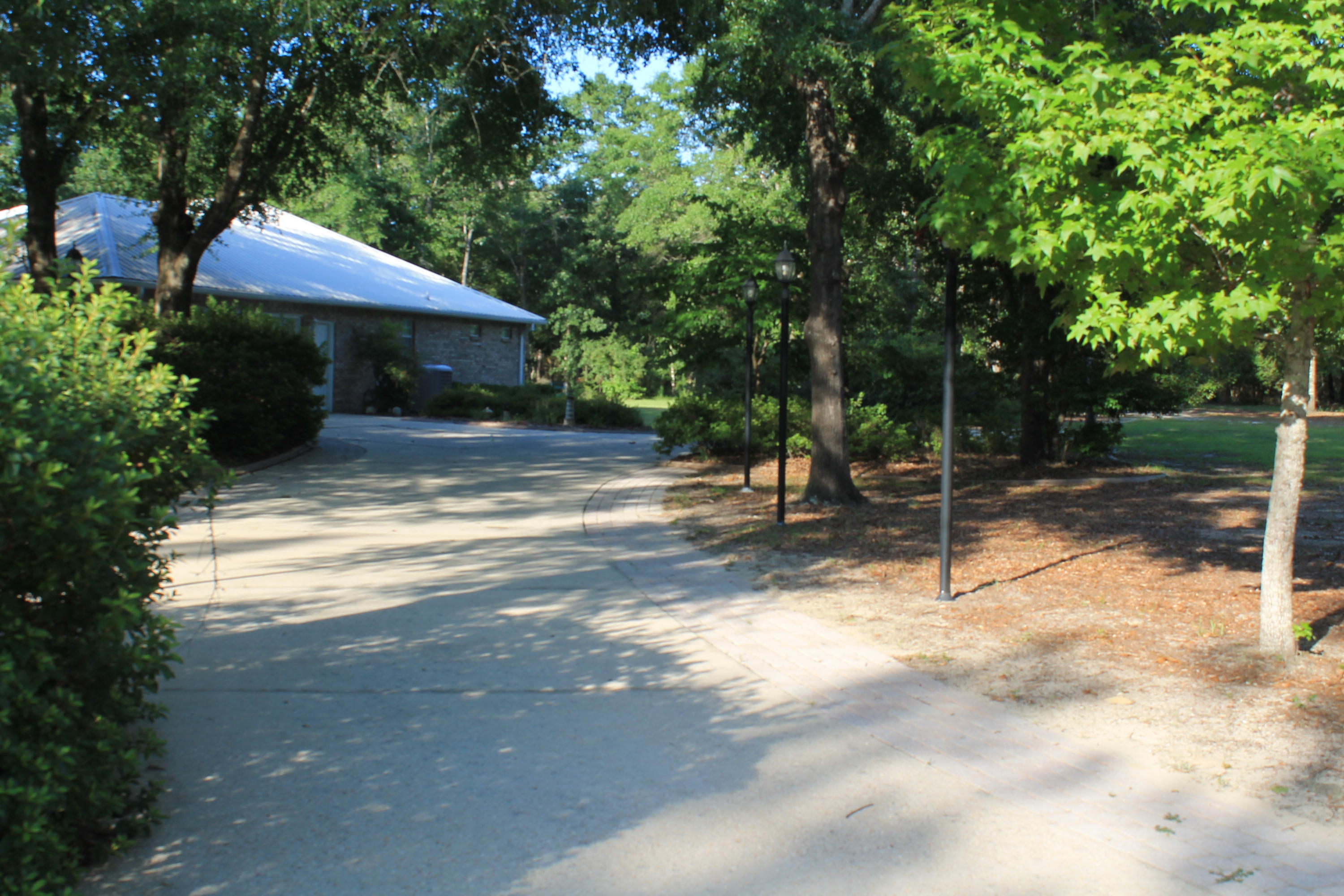 5876 Ward Ranch Road Crestview, FL 32536 - Photo 49 of 50 a backyard of a house with table and chairs