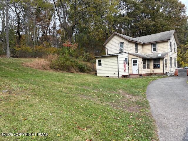 207 Munch Drive Henryville, PA 18332 - Photo 35 of 43 a view of a white house next to a yard with large trees