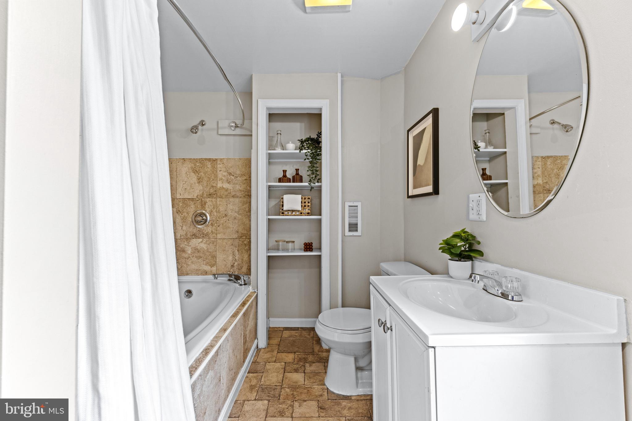 1505 South Hanover Street Baltimore, MD 21230 - Photo 16 of 30 a bathroom with a sink a toilet and a mirror
