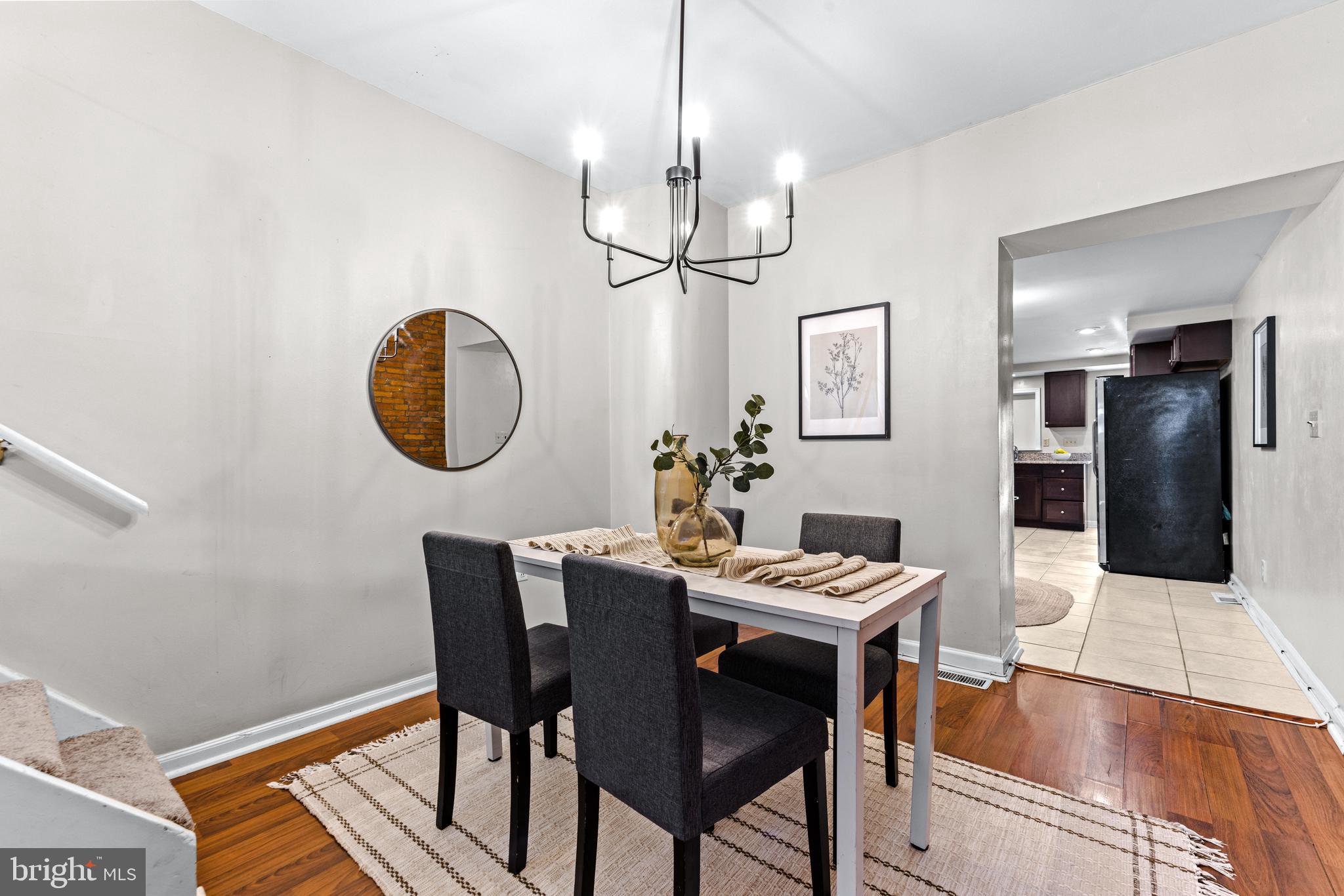 1505 South Hanover Street Baltimore, MD 21230 - Photo 4 of 30 a view of a dining room with furniture a chandelier and wooden floor