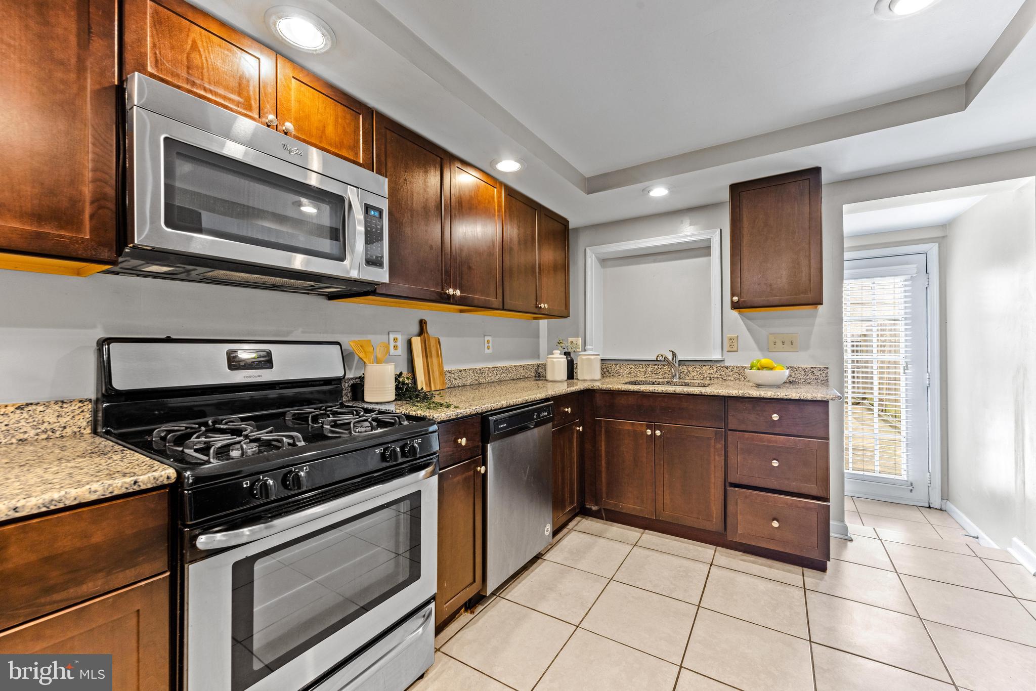 1505 South Hanover Street Baltimore, MD 21230 - Photo 6 of 30 a kitchen with stainless steel appliances granite countertop a stove a microwave and a sink