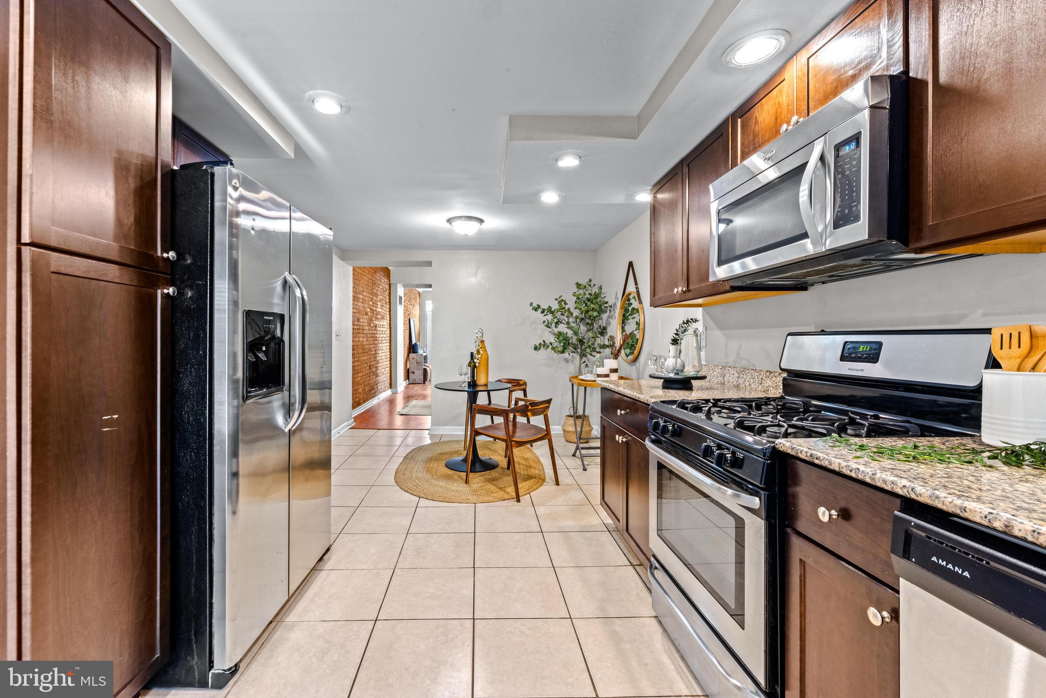 1505 South Hanover Street Baltimore, MD 21230 - Photo 8 of 30 a kitchen with stainless steel appliances granite countertop a stove a refrigerator and a microwave