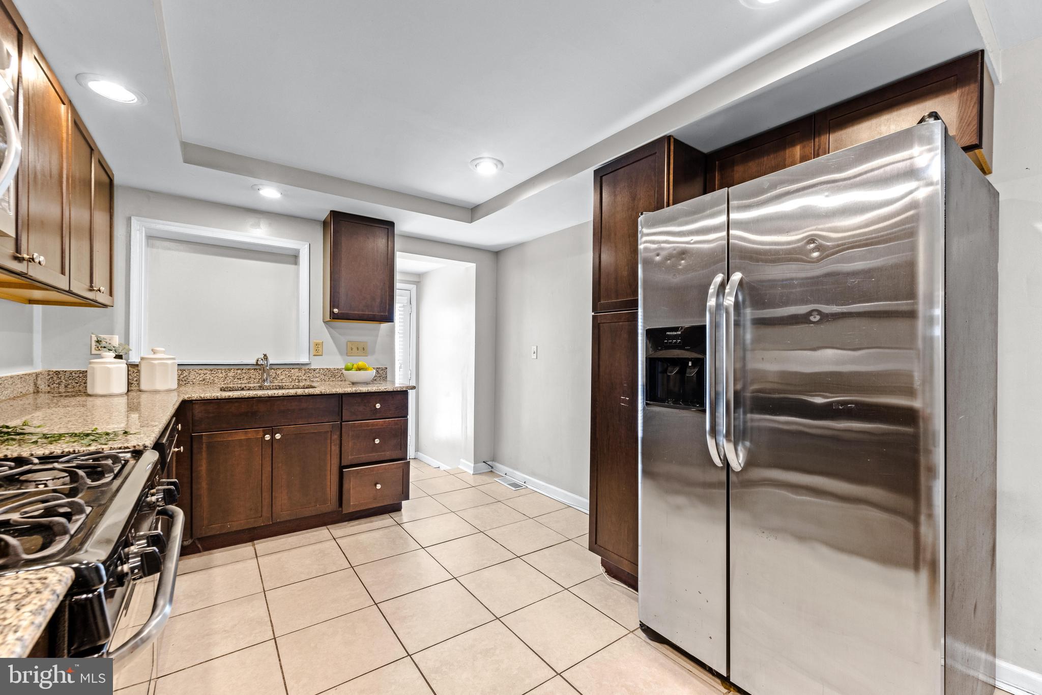 1505 South Hanover Street Baltimore, MD 21230 - Photo 9 of 30 a kitchen with stainless steel appliances granite countertop a refrigerator and a sink