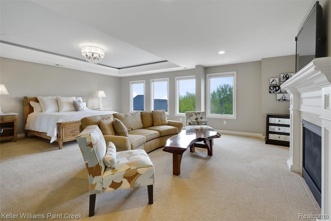 2888 North Addison Circle Rochester, MI 48306 - Photo 39 of 73 Wrap yourself in luxury in the spacious 25' x 22' Master Suite with 2-Way Gas Fireplace and decorative Tray Ceiling.