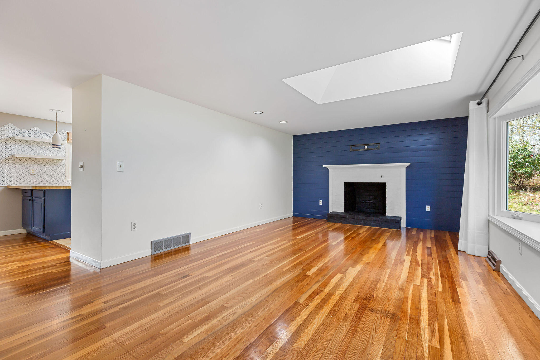 1197 Orleans-Harwich Road Harwich, MA 02645 - Photo 11 of 66 a view of empty room with wooden floor and fireplace