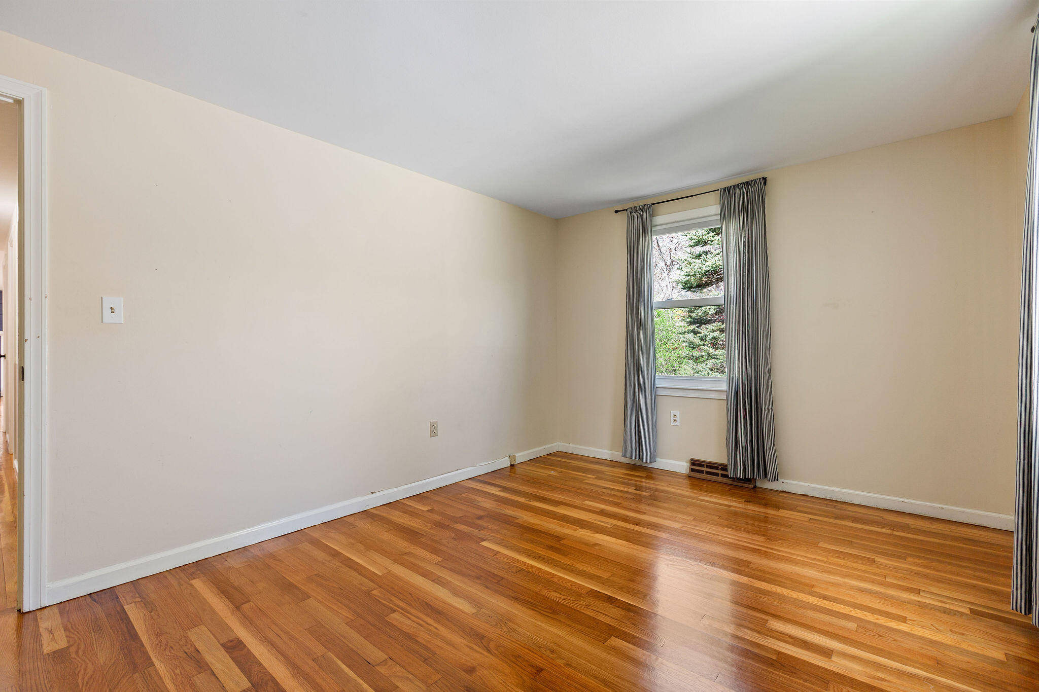 1197 Orleans-Harwich Road Harwich, MA 02645 - Photo 36 of 66 an empty room with wooden floor and windows