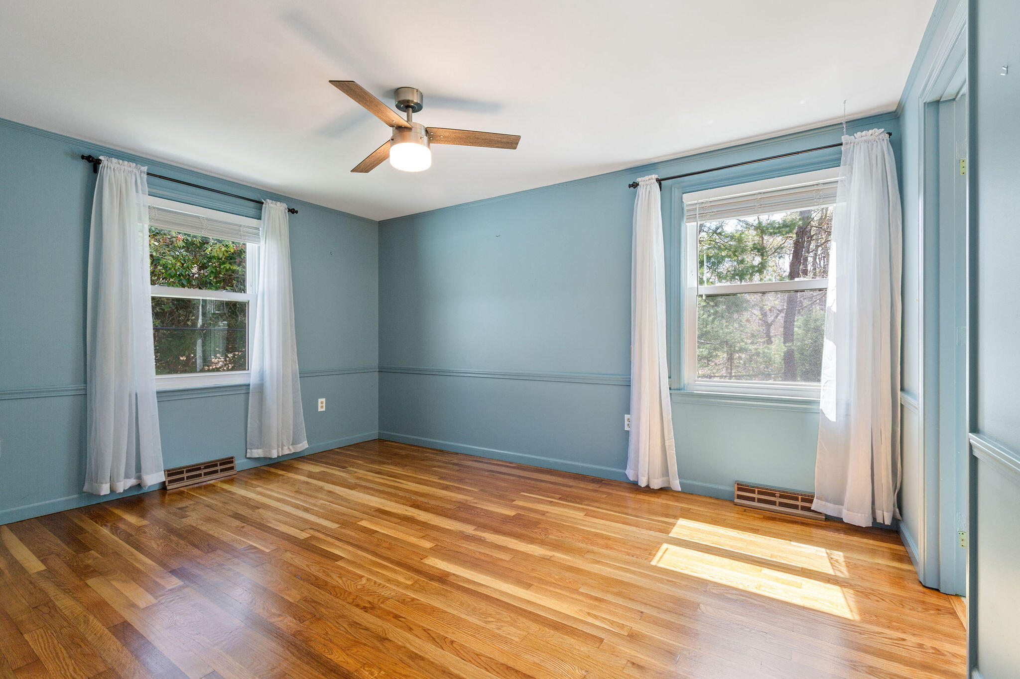 1197 Orleans-Harwich Road Harwich, MA 02645 - Photo 41 of 66 a view of an empty room with wooden floor and a window