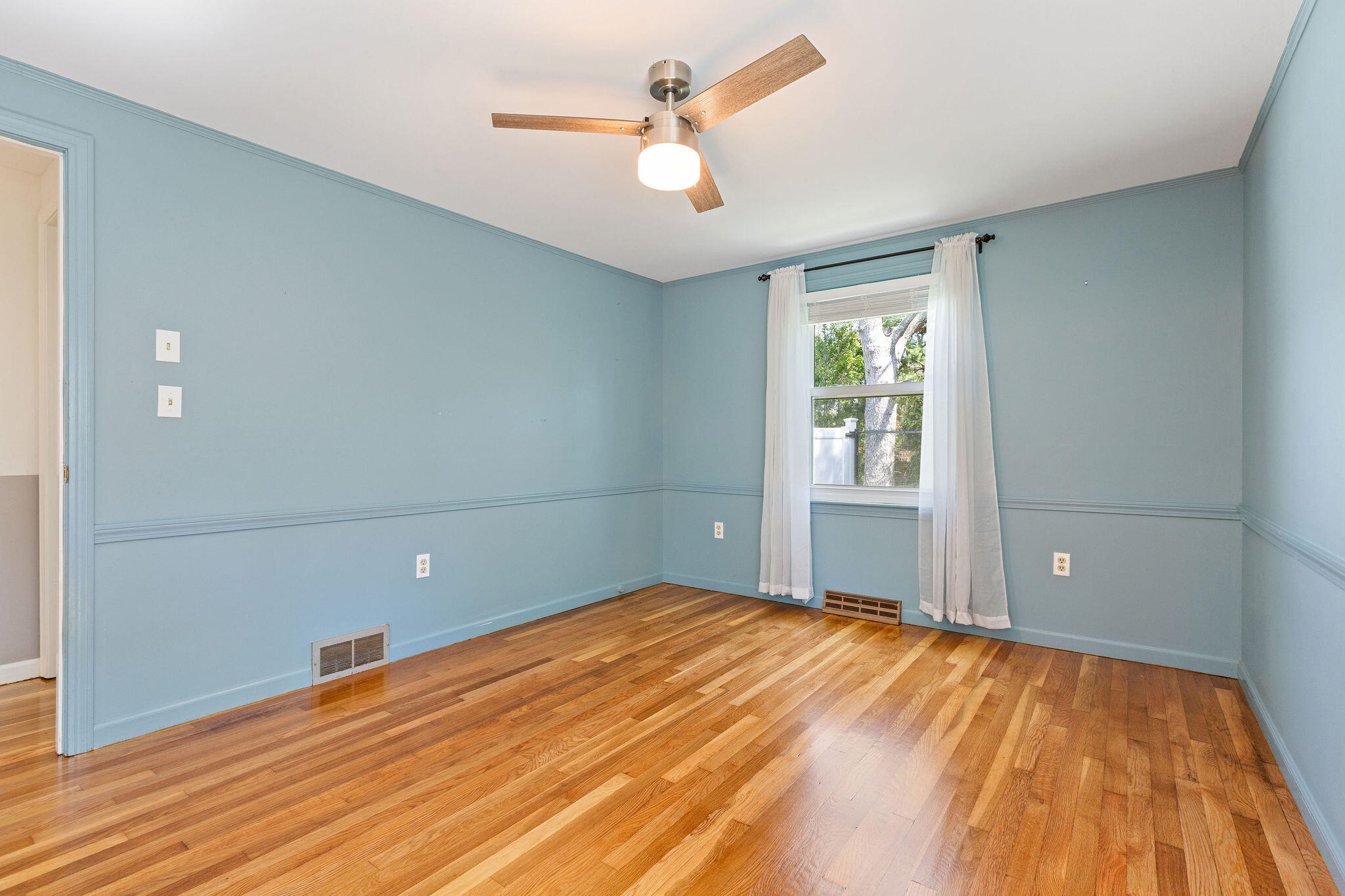 1197 Orleans-Harwich Road Harwich, MA 02645 - Photo 42 of 66 a view of a room with wooden floor and a ceiling fan