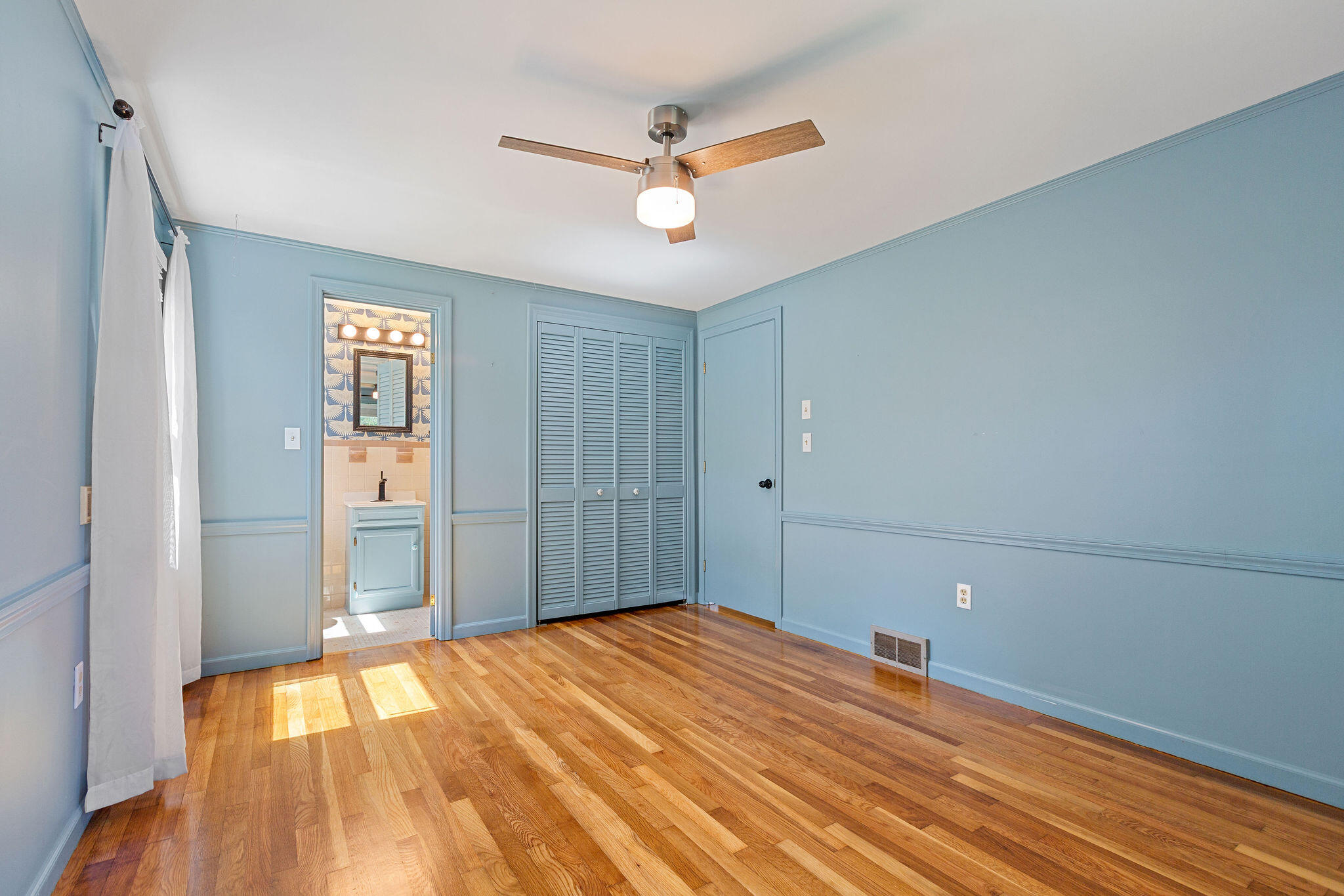 1197 Orleans-Harwich Road Harwich, MA 02645 - Photo 43 of 66 a bedroom with a bed and a chandelier fan