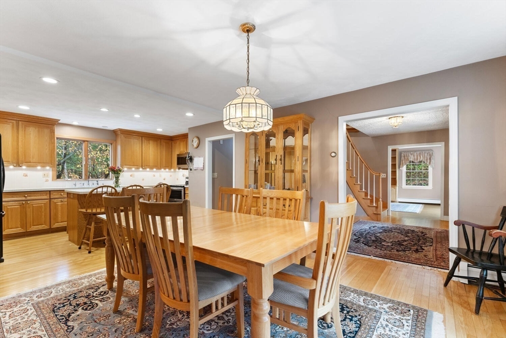 31 Girard Road Winchester, MA 01890 - Photo 11 of 38 a dining room with furniture a chandelier and wooden floor
