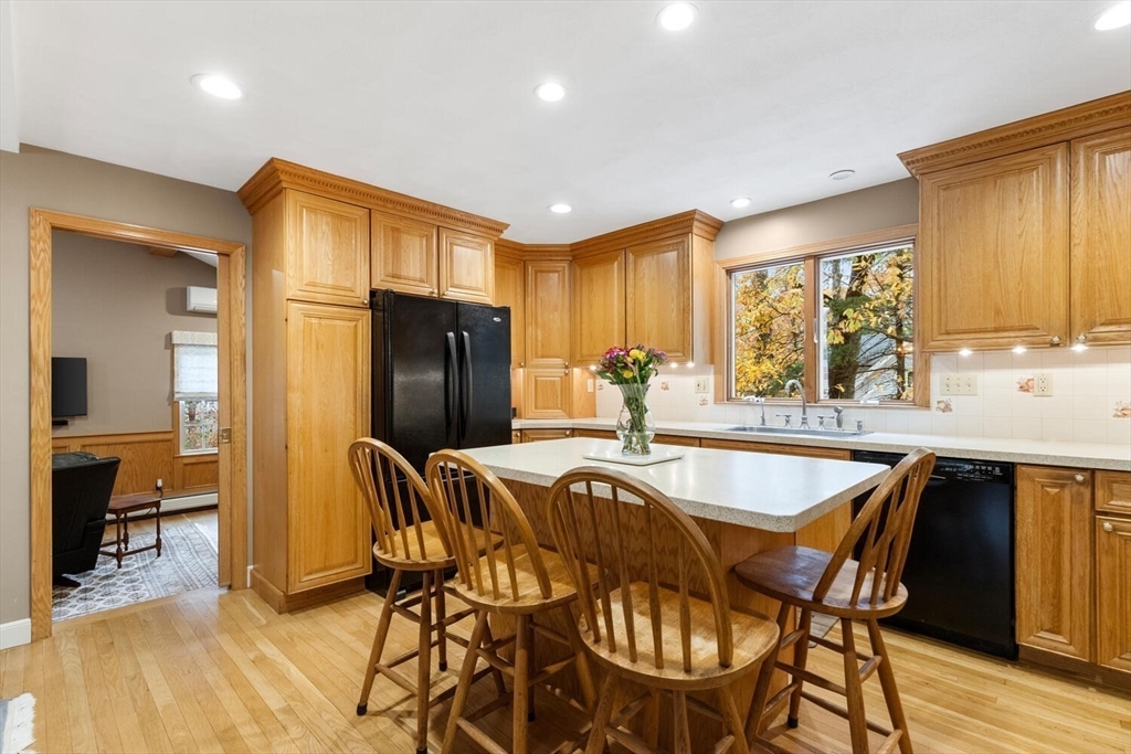 31 Girard Road Winchester, MA 01890 - Photo 12 of 38 a dining hall with stainless steel appliances granite countertop a dining table and chairs