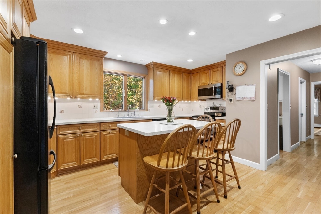 31 Girard Road Winchester, MA 01890 - Photo 13 of 38 a kitchen with granite countertop lots of white cabinets a sink a window and stainless steel appliances