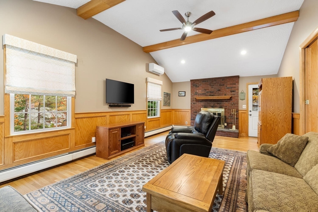 31 Girard Road Winchester, MA 01890 - Photo 16 of 38 a living room with furniture and a flat screen tv