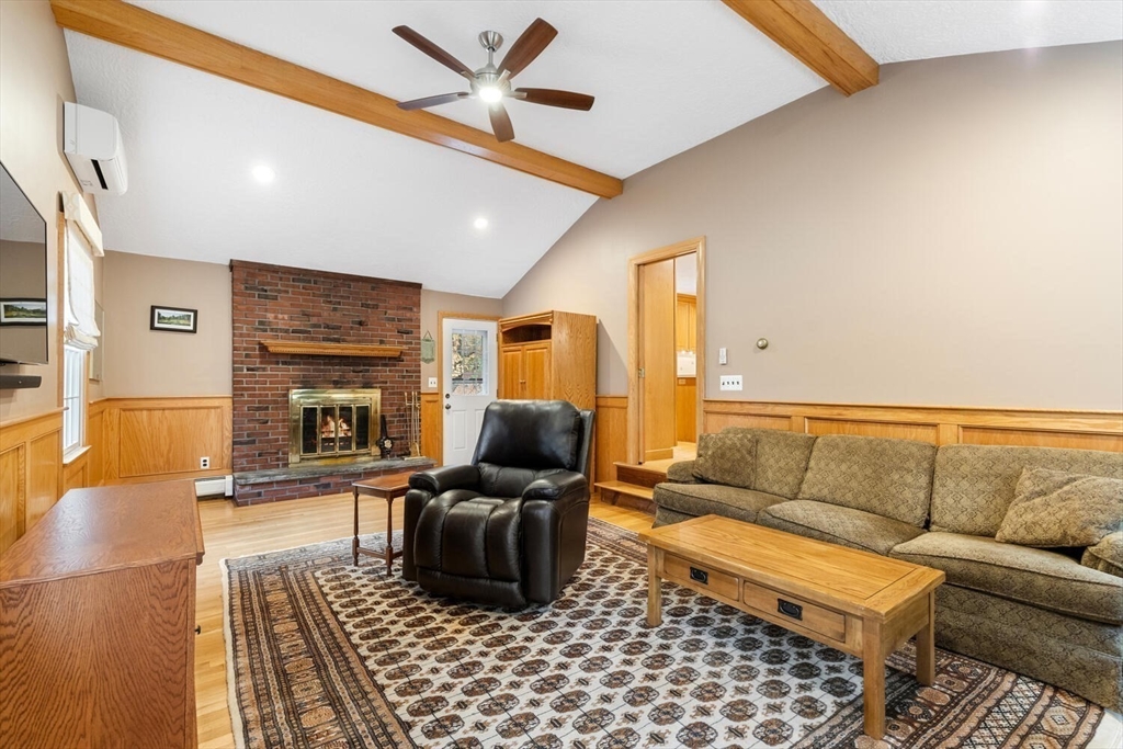 31 Girard Road Winchester, MA 01890 - Photo 18 of 38 a living room with furniture and a fireplace