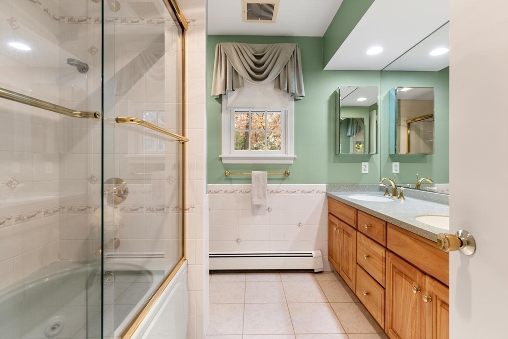 31 Girard Road Winchester, MA 01890 - Photo 24 of 38 a bathroom with a double vanity sink mirror and shower
