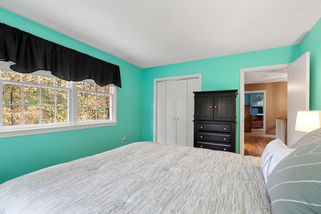 31 Girard Road Winchester, MA 01890 - Photo 26 of 38 a bedroom with a bed and wooden floor
