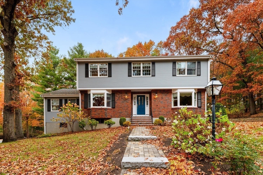 31 Girard Road Winchester, MA 01890 - Photo 4 of 38 a front view of a house with a yard