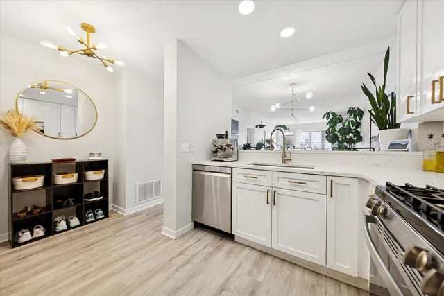 a kitchen with wooden floor and white appliances