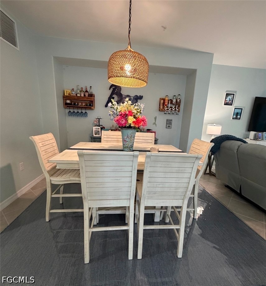 14191 Poppy Fld Loop, Unit 5312 Punta Gorda, FL 33955 - Photo 14 of 41 a dining room with furniture a chandelier and wooden floor