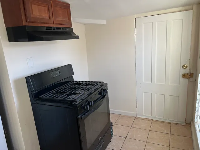 a kitchen with granite countertop a stove and a microwave