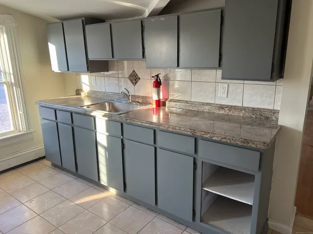 a kitchen with sink cabinets and window