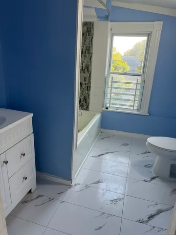 a bathroom with a bathtub and a toilet