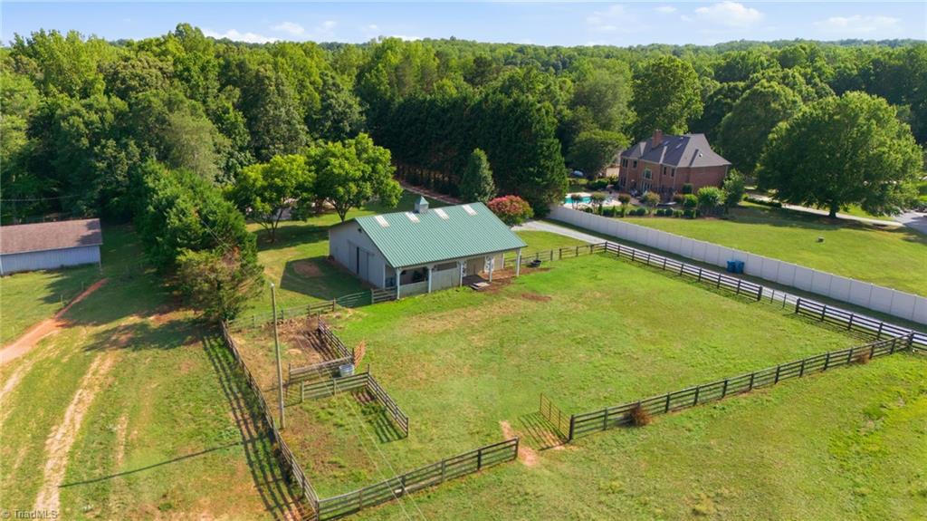 8861 Boylston Road Colfax, NC 27235 - Photo 44 of 50 Aerial view of the Morton-built barn, riding arena, and fenced paddocks.