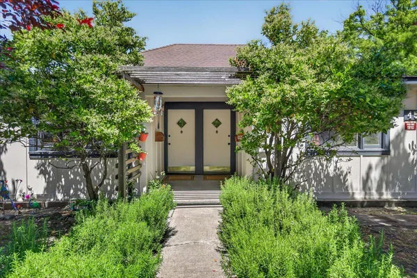 a front view of a house with garden