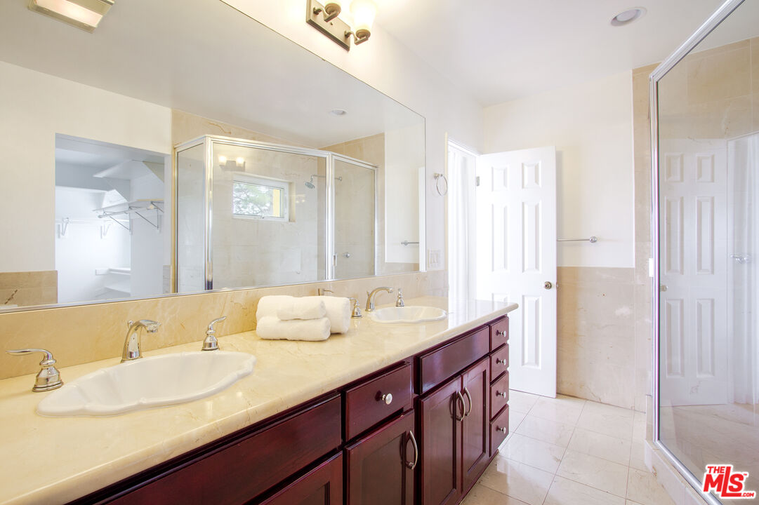 1244 Stradella Road Los Angeles, CA 90077 - Photo 13 of 18 a bathroom with a double vanity sink and a mirror