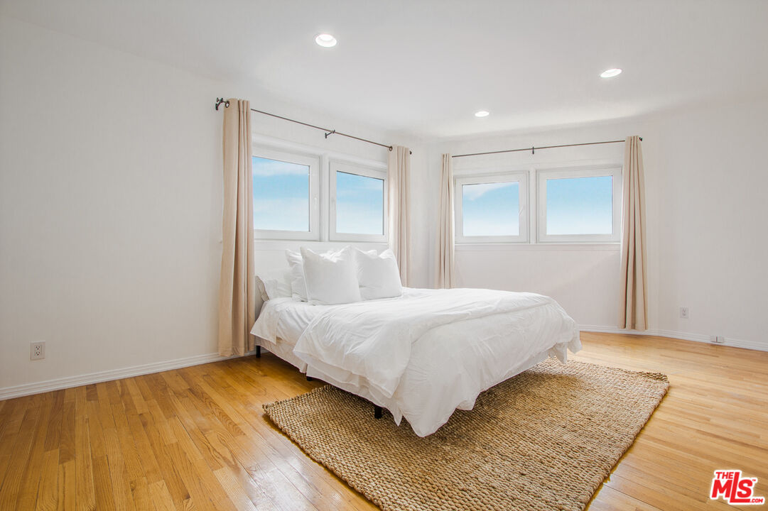 1244 Stradella Road Los Angeles, CA 90077 - Photo 14 of 18 a bedroom with a bed and wooden floor