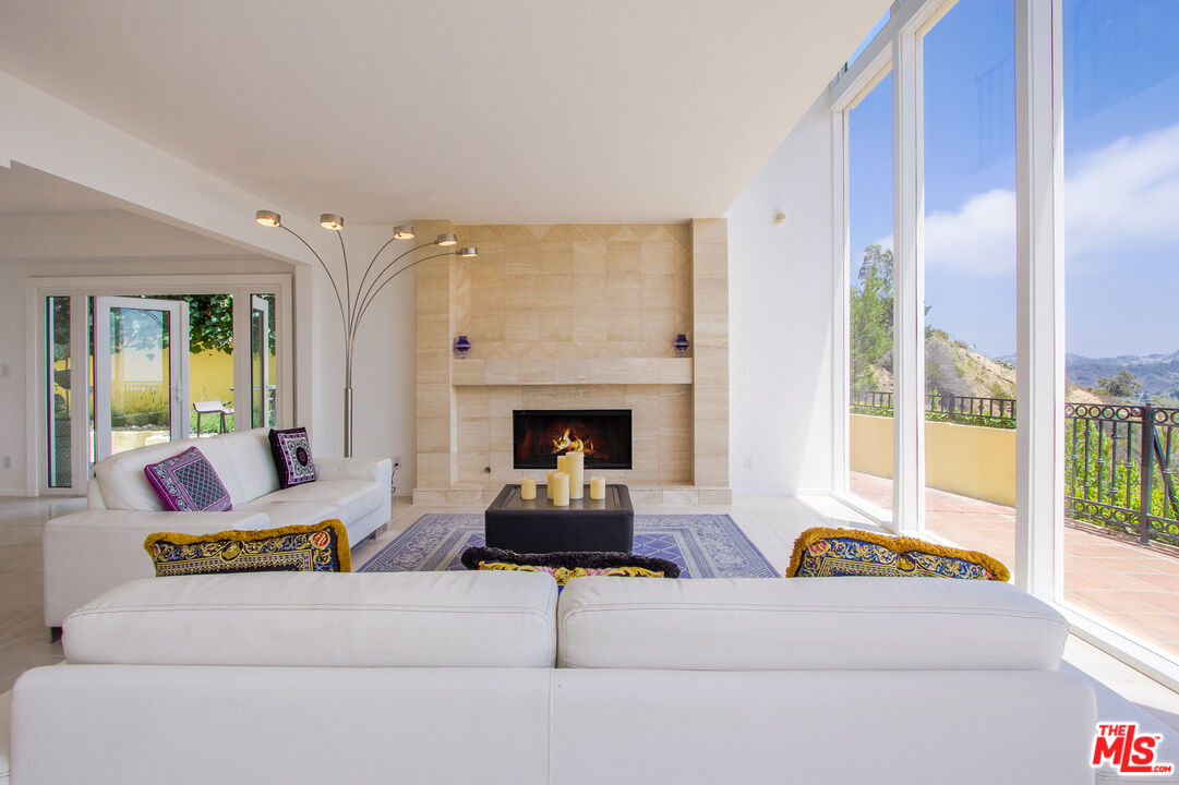 1244 Stradella Road Los Angeles, CA 90077 - Photo 5 of 18 a living room with furniture and a fireplace