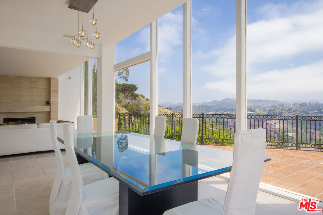 1244 Stradella Road Los Angeles, CA 90077 - Photo 6 of 18 a living room with hardwood floor and a balcony