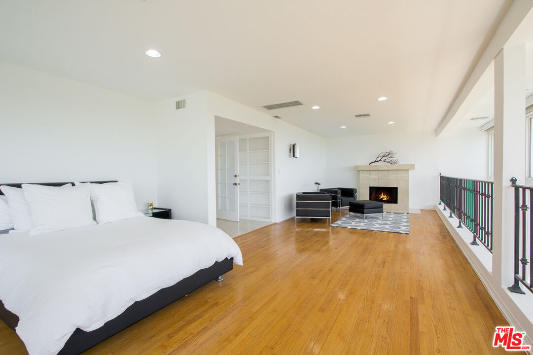 1244 Stradella Road Los Angeles, CA 90077 - Photo 10 of 18 a bedroom with a bed and furniture