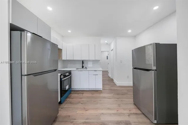 a kitchen with a refrigerator and a sink
