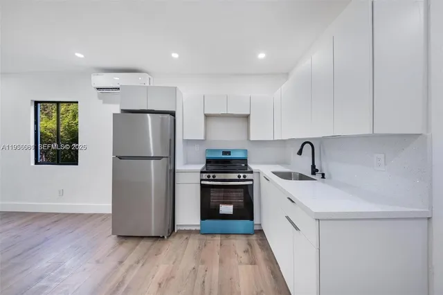 a kitchen with a refrigerator sink and stove