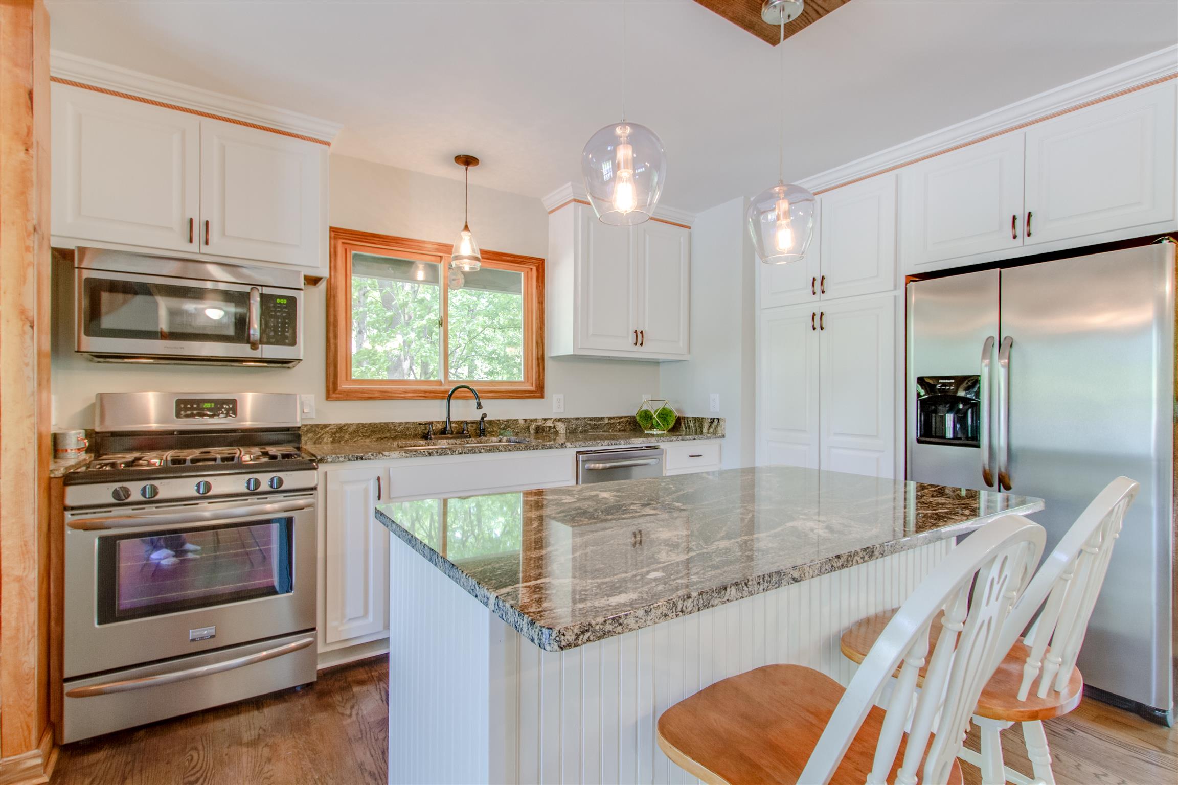 6353 Morton Road Greenbrier, TN 37073 - Photo 15 of 30 a kitchen with stainless steel appliances granite countertop a stove a sink and a refrigerator