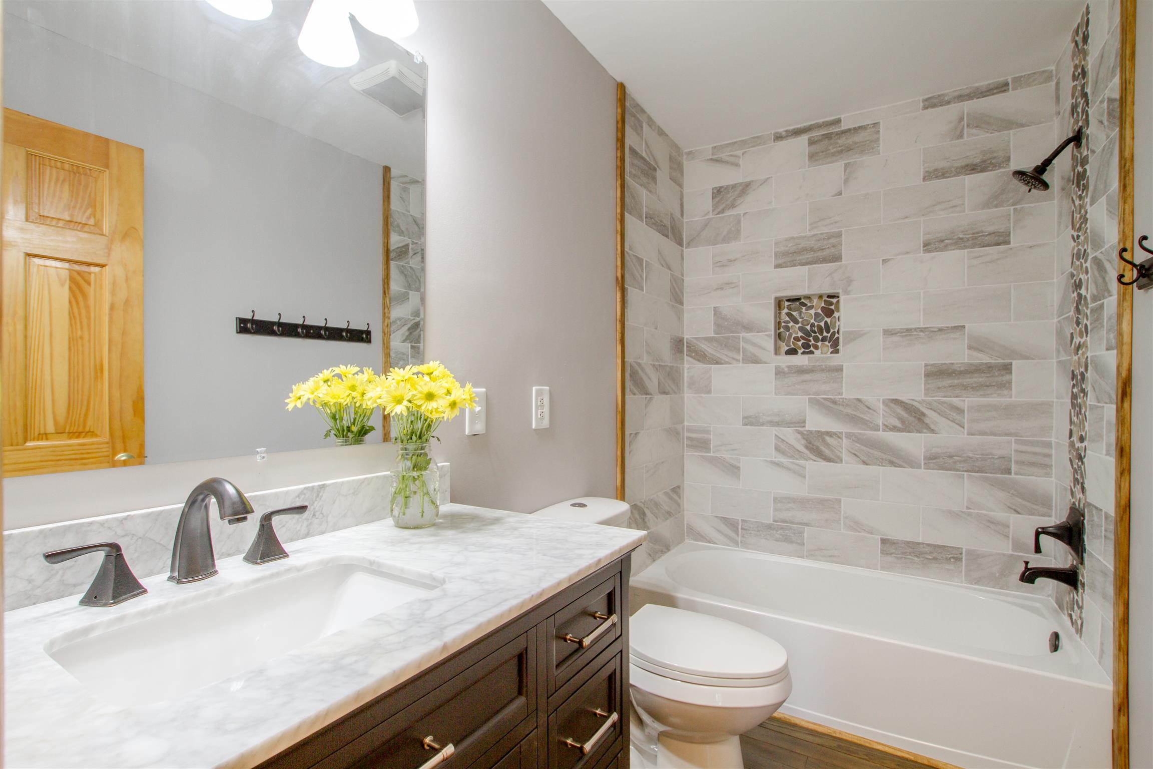 6353 Morton Road Greenbrier, TN 37073 - Photo 16 of 30 a bathroom with a granite countertop sink a toilet and shower