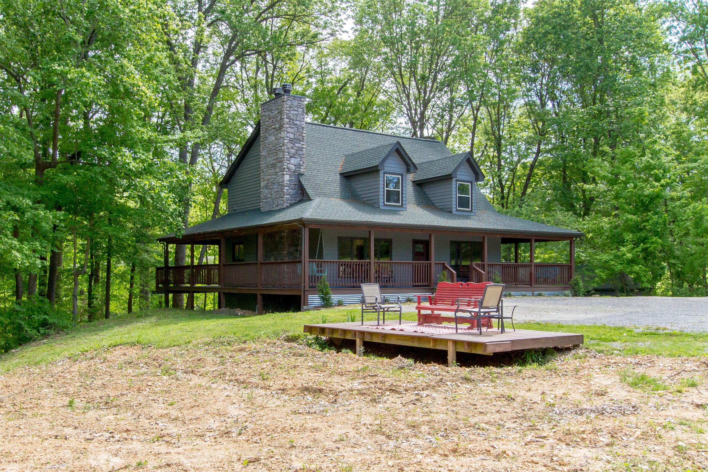6353 Morton Road Greenbrier, TN 37073 - Photo 5 of 30 a front view of a house with a garden and sitting area