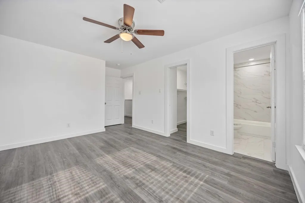 7811 Laura Koppe Road, Unit A Houston, TX 77028 - Photo 12 of 23 a view of empty room with wooden floor and ceiling fan
