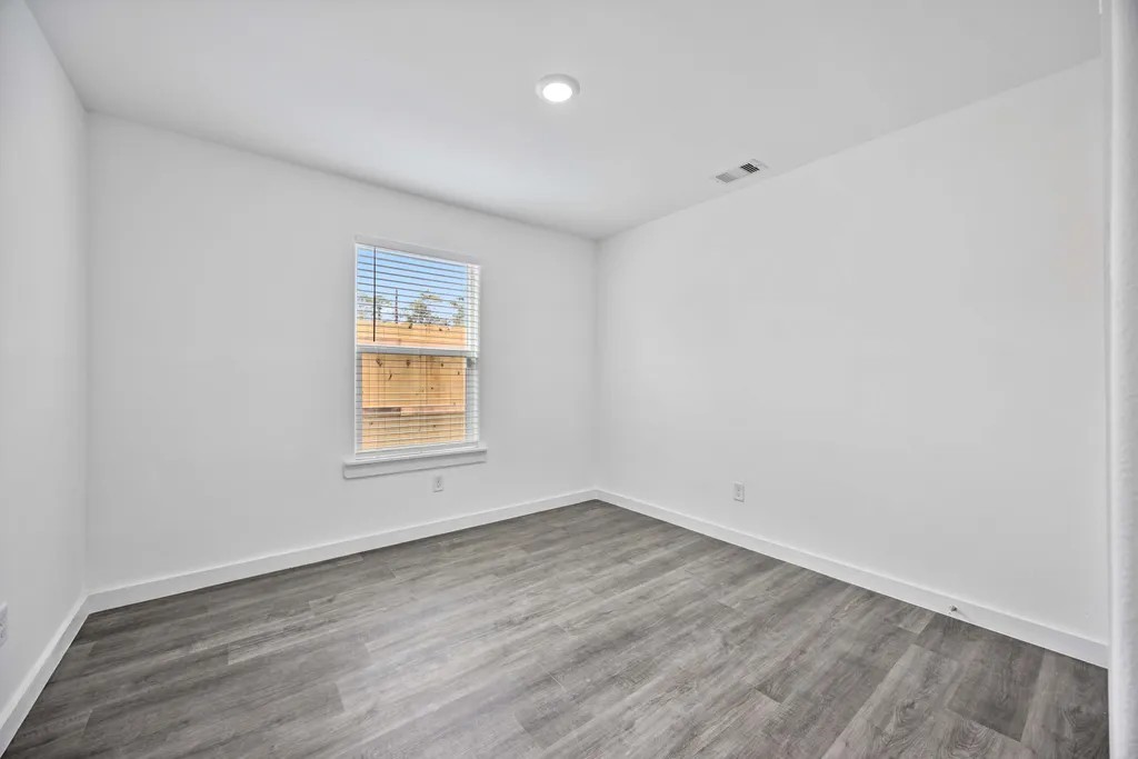 7811 Laura Koppe Road, Unit A Houston, TX 77028 - Photo 15 of 23 wooden floor in an empty room with a window