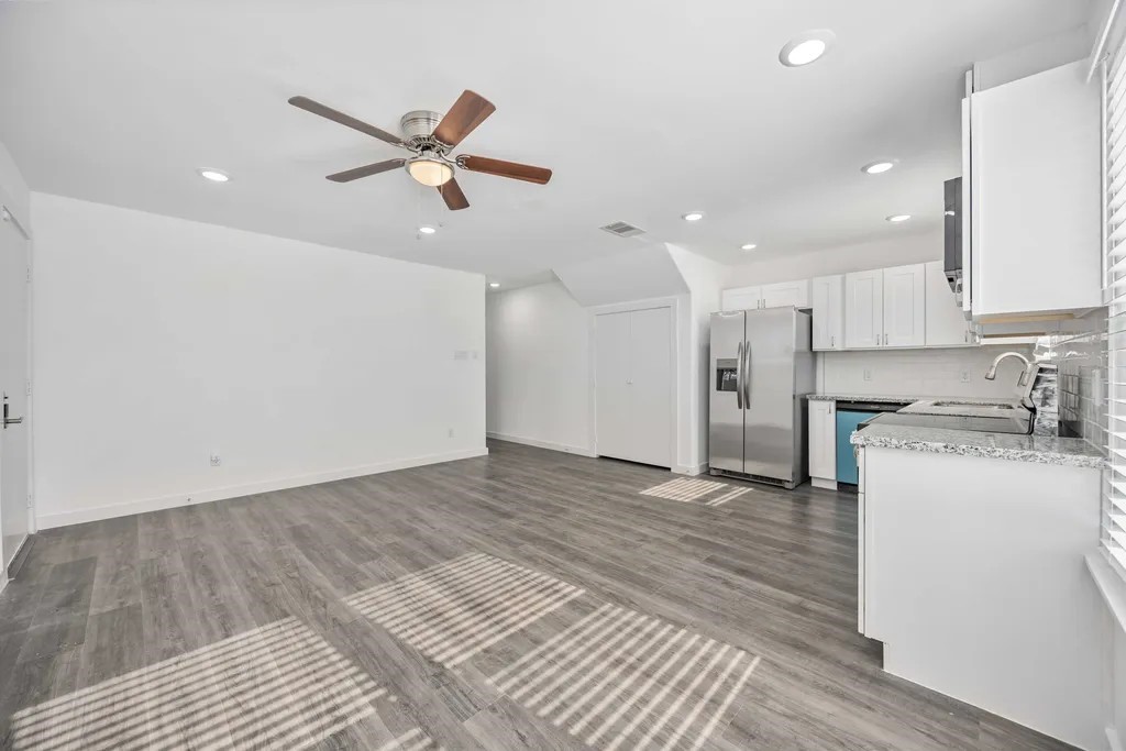 7811 Laura Koppe Road, Unit A Houston, TX 77028 - Photo 2 of 23 a view of a kitchen with a sink and dishwasher a refrigerator with wooden floor