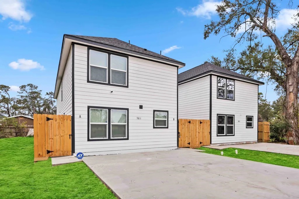7811 Laura Koppe Road, Unit A Houston, TX 77028 - Photo 23 of 23 a front view of a house with a yard and garage