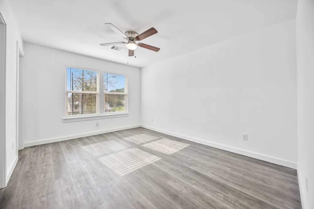 7811 Laura Koppe Road, Unit A Houston, TX 77028 - Photo 8 of 23 a view of an empty room with wooden floor and a window