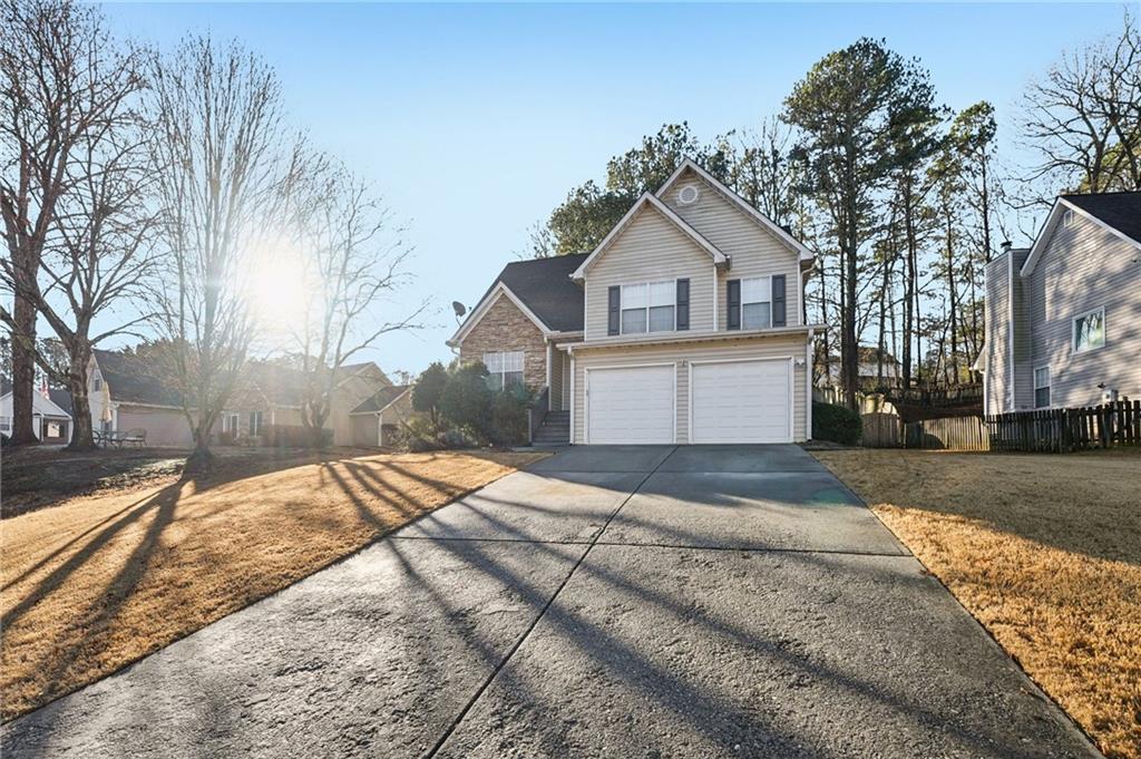 1620 Rushing River Way Suwanee, GA 30024 - Photo 1 of 1 a front view of a house with a yard covered in snow
