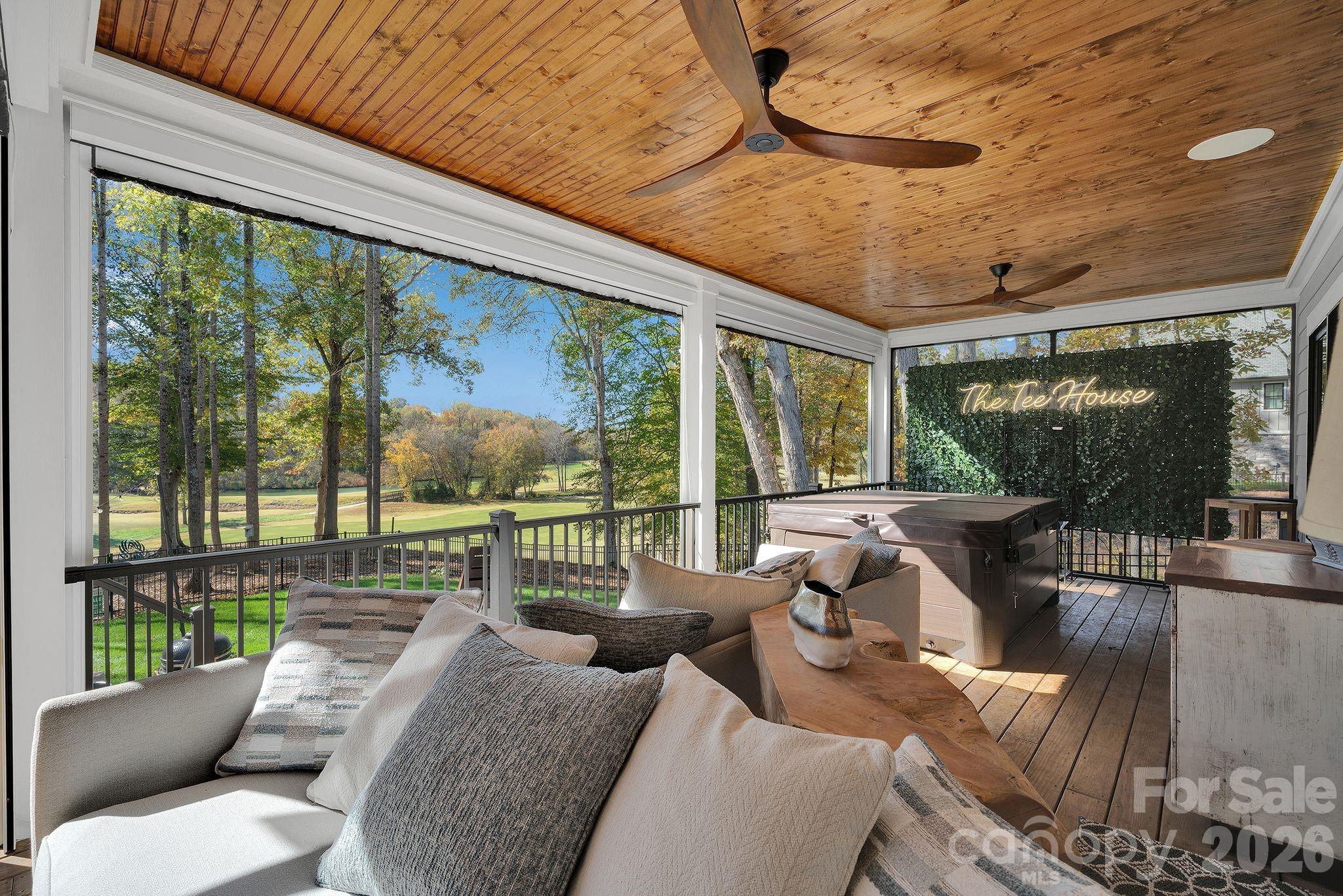 a balcony with furniture and a floor to ceiling window